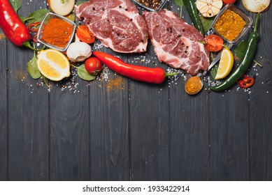 Raw Pork Meat With Spices And Vegetables On Wooden Table