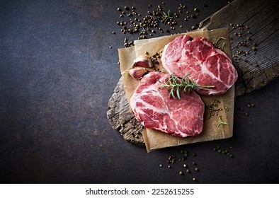 Raw pork neck with spices and herbs for grilled steaks - Powered by Shutterstock