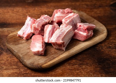 Raw pork ribs chopped on a cutting wooden board. - Powered by Shutterstock