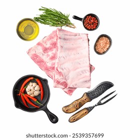 Raw pork ribs are displayed alongside fresh herbs, spices, olive oil, and a cast-iron skillet, highlighting essential ingredients for a delicious meal preparation Isolate Isolated on white background - Powered by Shutterstock