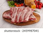 Raw pork ribs over board for cooking