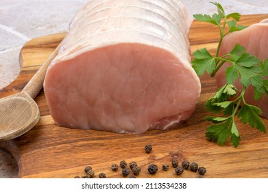 Raw Pork Roast On A Wooden Board 