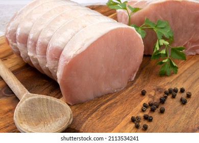 Raw Pork Roast On A Wooden Board 