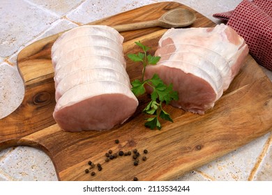 Raw Pork Roast On A Wooden Board 