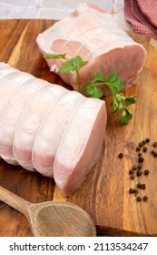 Raw Pork Roast On A Wooden Board 