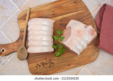 Raw Pork Roast On A Wooden Board 