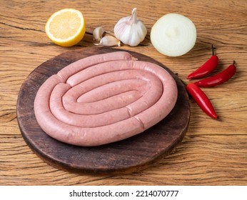 Raw Pork Sausage On A Wooden Board With Silician Lemon And Seasonings.