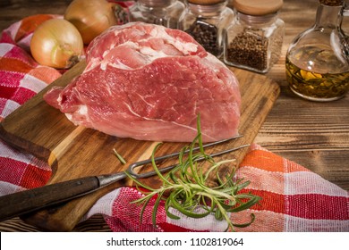 Raw Pork Shoulder On Cutting Board With Knife.