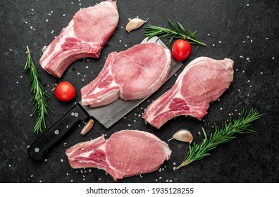 raw pork steaks on stone background
