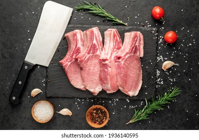 raw pork steaks on stone background 