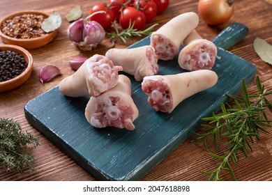 Raw Pork Tails On Chopping Board