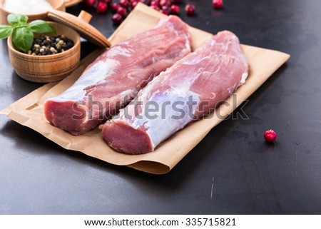 Raw pork tenderloin on craft paper ready to cook