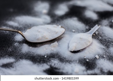 Raw Powdered Baking Soda In A Antique Spoon On Wooden Surface Along With Some More In A Plastic Spoon.Horizontal Shot.