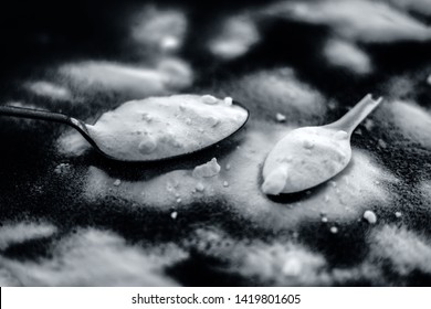 Raw Powdered Baking Soda In A Antique Spoon On Wooden Surface Along With Some More In A Plastic Spoon.Horizontal Shot.