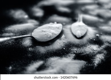 Raw Powdered Baking Soda In A Antique Spoon On Wooden Surface Along With Some More In A Plastic Spoon. Horizontal And Top Shot.