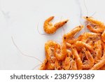 Raw prawn shrimps on white marble background with copy space top view