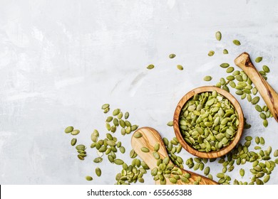 Raw pumpkin seeds, food background, top view