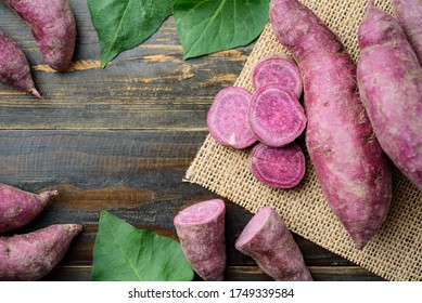 Raw purple sweet potatoes on wooden background, Organic vegetable