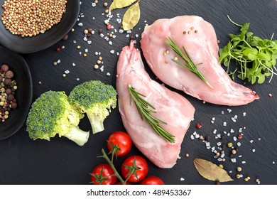 Raw Rabbit Haunches Seasoned With Herbs And Spices Ready For Grilling, Overhead View With Copyspace