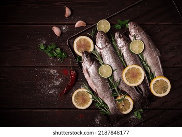 Raw Rainbow Trout, With Lemon And Herbs, On A Wooden Table, No People,