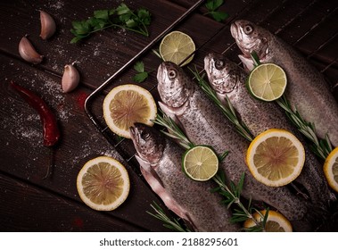 Raw Rainbow Trout, With Lemon And Herbs, On A Wooden Table, No People,