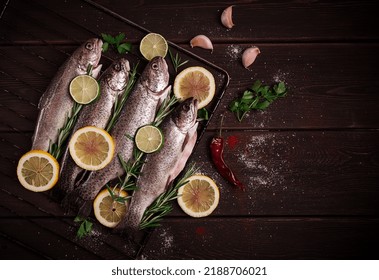 Raw Rainbow Trout, With Lemon And Herbs, On A Wooden Table, No People,