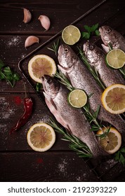 Raw Rainbow Trout, With Lemon And Herbs, On A Wooden Table, No People,