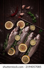 Raw Rainbow Trout, With Lemon And Herbs, On A Wooden Table, No People,