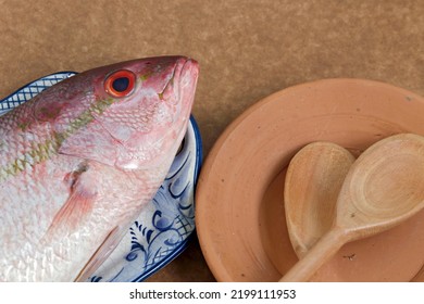 Raw Red Snapper Fish On Clay Plate, Ready To Season