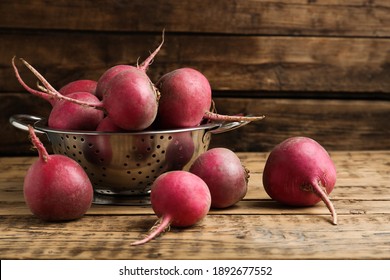 Raw red turnips on wooden table, closeup
