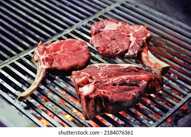 Raw Ribeye Steak Bone In Cooking On The Grill