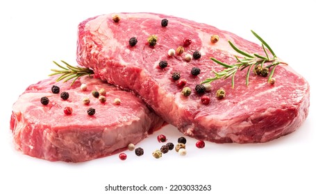 Raw ribeye steaks with peppercorn and rosemary isolated on white background. Closeup.  - Shutterstock ID 2203033263