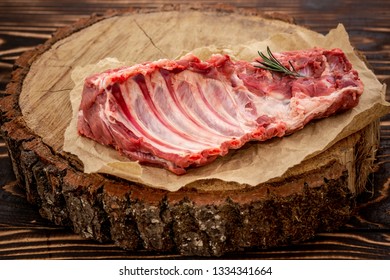 Raw ribs meat with herbs, salt, spices and other ingredients. Top flat view. - Shutterstock ID 1334341664