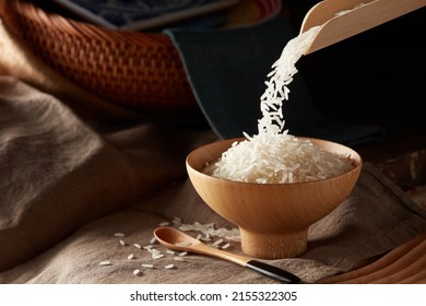 Raw rice in wooden bowl - Shutterstock ID 2155322305