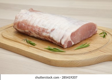 Raw Rolled Pork Roast On Chopping Board