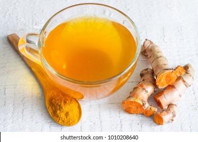 Raw Roots Of Tumeric And Tea On White Planks Detox Concept
