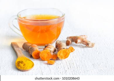 Raw Roots Of Tumeric And Tea On White Planks Detox Concept
