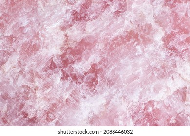 Raw Rose quartz stone textured surface background.