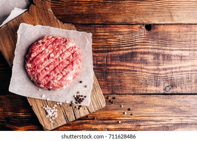 Raw Round Patty With Spices On Wax Paper For Burger. View From Above.