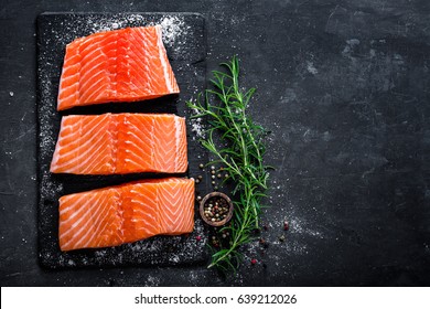 Raw salmon filet on dark slate background, wild atlantic fish - Shutterstock ID 639212026