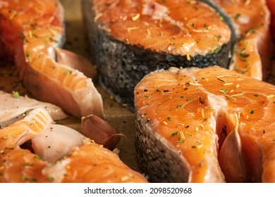 Raw Salmon Filets With Herbs And Spices On Baking Tray