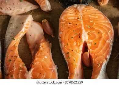 Raw Salmon Filets With Herbs And Spices On Baking Tray