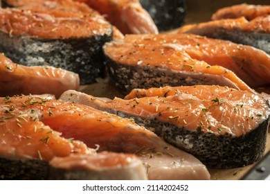 Raw Salmon Filets With Herbs And Spices On Baking Tray