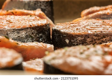 Raw Salmon Filets With Herbs And Spices On Baking Tray