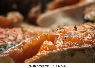 Raw Salmon Filets With Herbs And Spices On Baking Tray