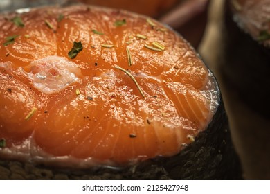 Raw Salmon Filets With Herbs And Spices On Baking Tray