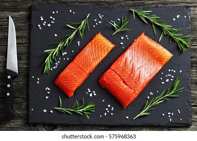 Raw Salmon Fillet With Fresh Rosemary,. Salt On Slate Plate On Old Dark Wooden Table With Knife, View From Above, Close-up