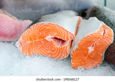 raw salmon fillet on ice of market desk