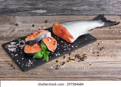 Raw salmon fish steaks on cutting board
