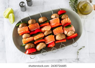 raw salmon skewers with vegetables. cooking summer recipe on marble